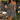 A woman stands in a sunny backyard patio setting wearing a black and white gingham tiered mini dress, holding a wine glass and carrying a black handbag.
